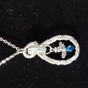 And weaved pendant with a sapphire angel Crystal in the center a-in chain